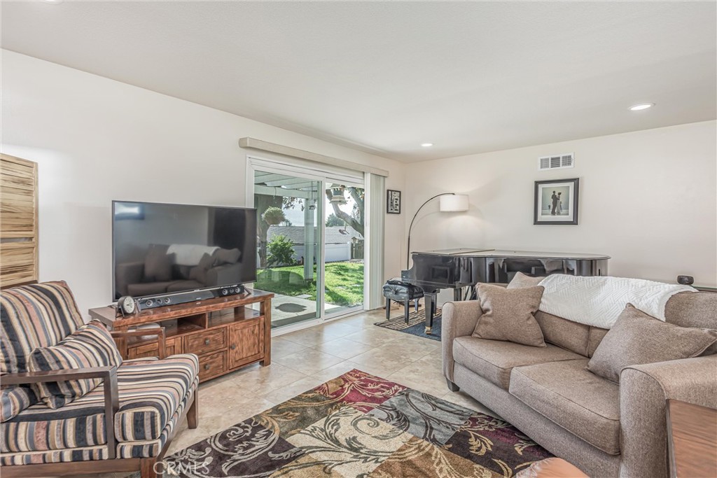 8651 Holly Street Rancho Cucamonga, CA 91701 - Photo 3 of 29 a living room with furniture and a flat screen tv