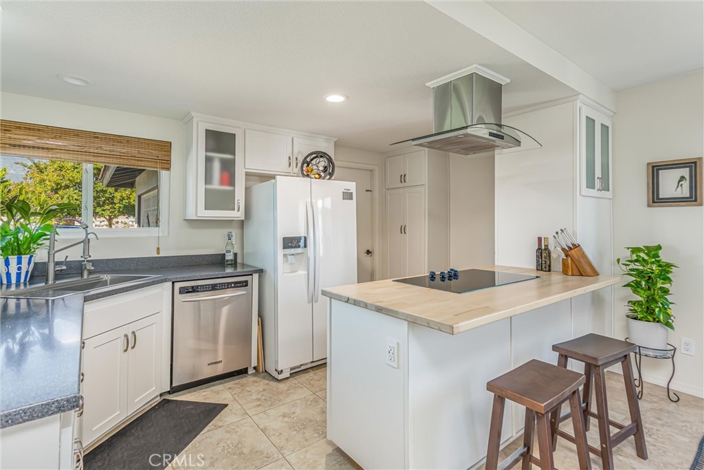 8651 Holly Street Rancho Cucamonga, CA 91701 - Photo 6 of 29 a kitchen with stainless steel appliances granite countertop a sink stove and refrigerator