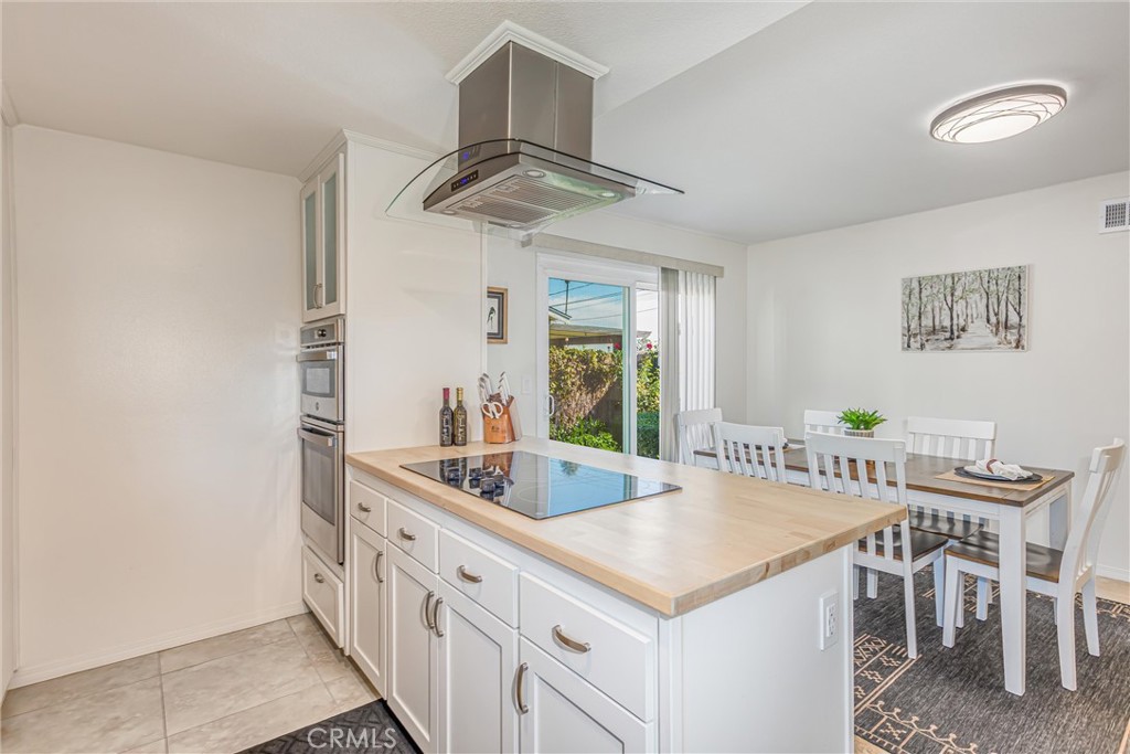 8651 Holly Street Rancho Cucamonga, CA 91701 - Photo 9 of 29 a kitchen with stainless steel appliances granite countertop a sink and a refrigerator