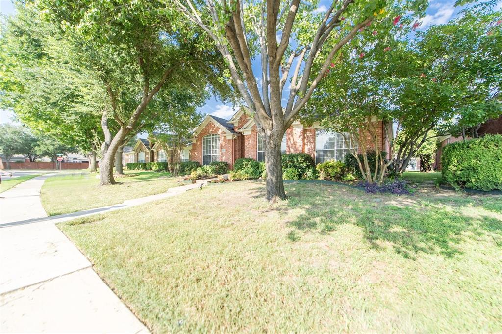 334 Touchdown Drive Irving, TX 75063 - Photo 2 of 32 Brick exterior residence featuring a symmetrical facade, multiple windows, and a paved sidewalk