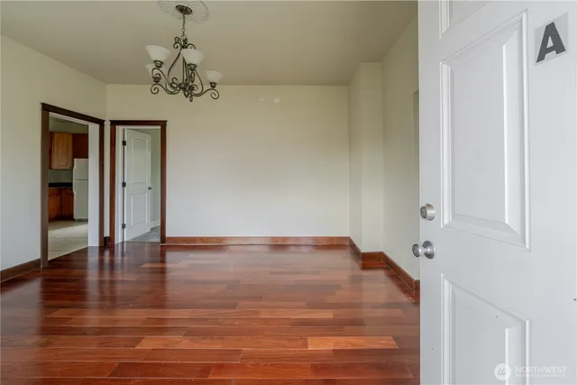 a view of an empty room with wooden floor