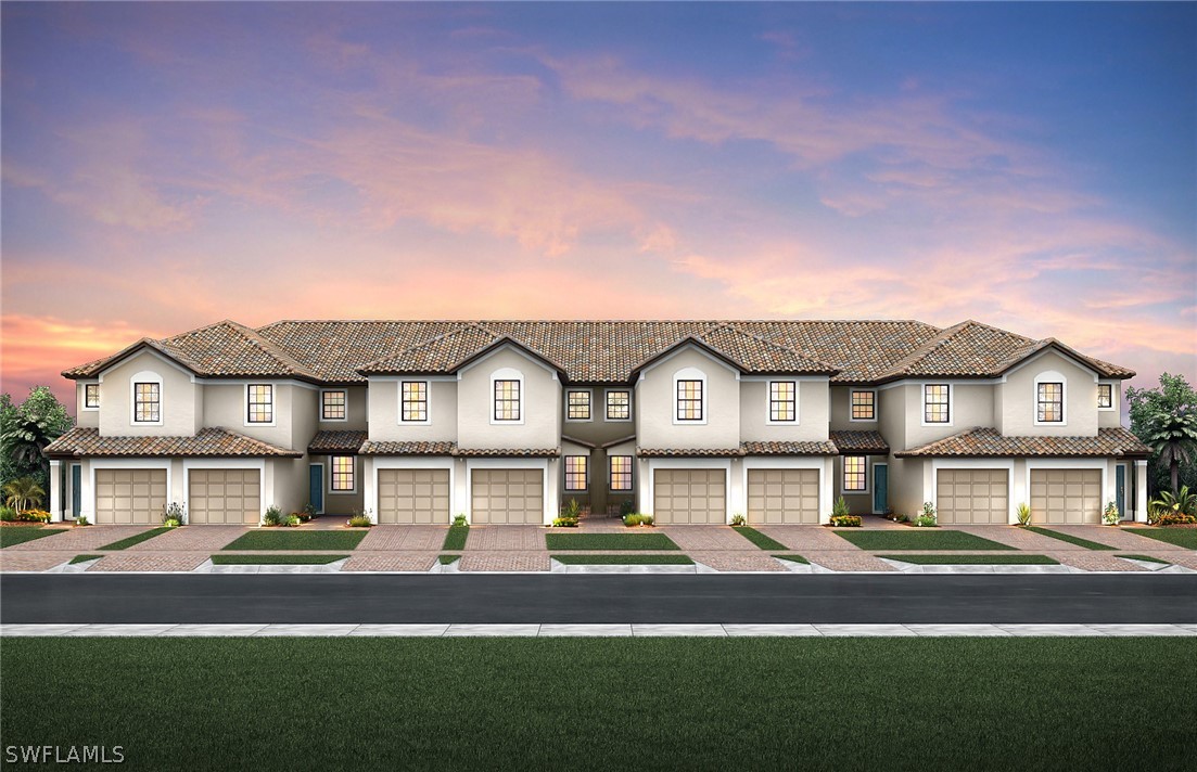 5694 Mayflower Way, Unit 505 Immokalee, FL 34142 - Photo 1 of 1 a front view of a house with a yard