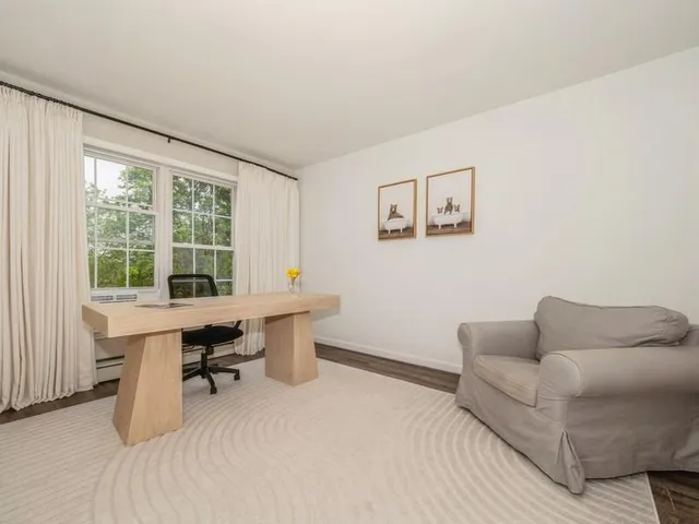 a work room with furniture and a window