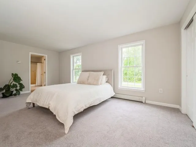 a spacious bedroom with a bed and a window