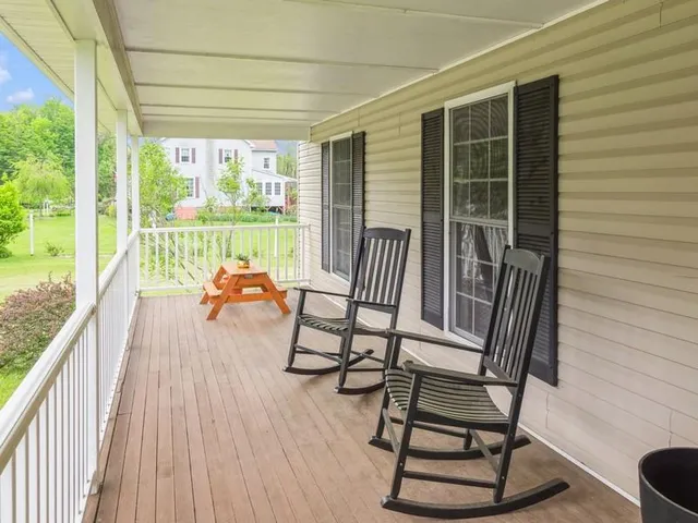 a sitting area with furniture and wooden floor