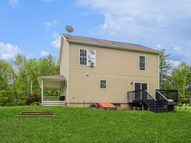 a backyard of a house with table and chairs