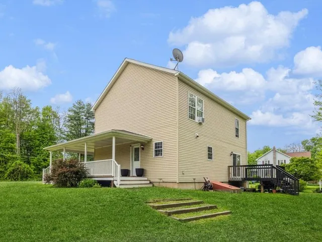 a front view of a house with a garden and yard