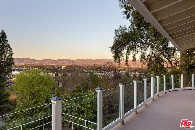 a view of a balcony with trees