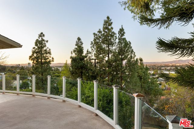 a balcony with trees in front of it