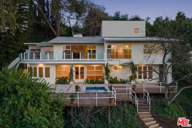an aerial view of a house with a yard and potted plants