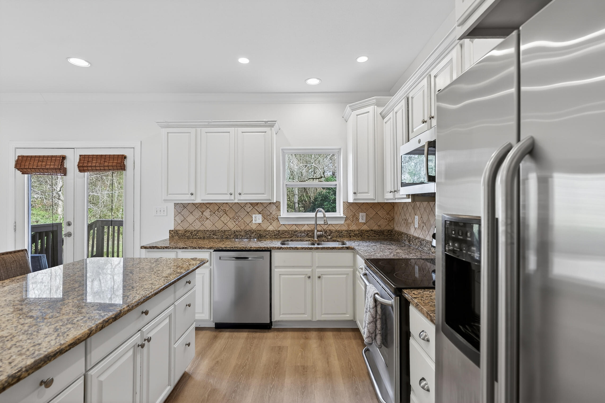 159 7th Street Santa Rosa Beach, FL 32459 - Photo 12 of 53 a kitchen with stainless steel appliances granite countertop a sink stove and refrigerator