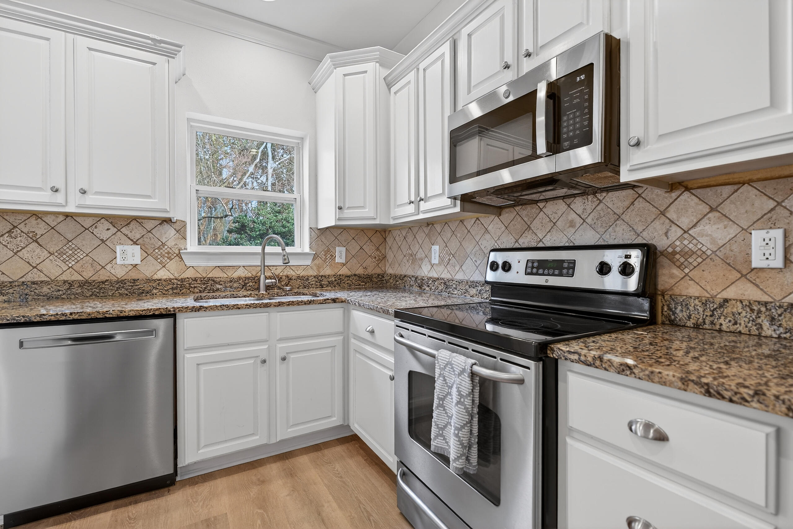 159 7th Street Santa Rosa Beach, FL 32459 - Photo 13 of 53 a kitchen with granite countertop white cabinets stainless steel appliances and a sink