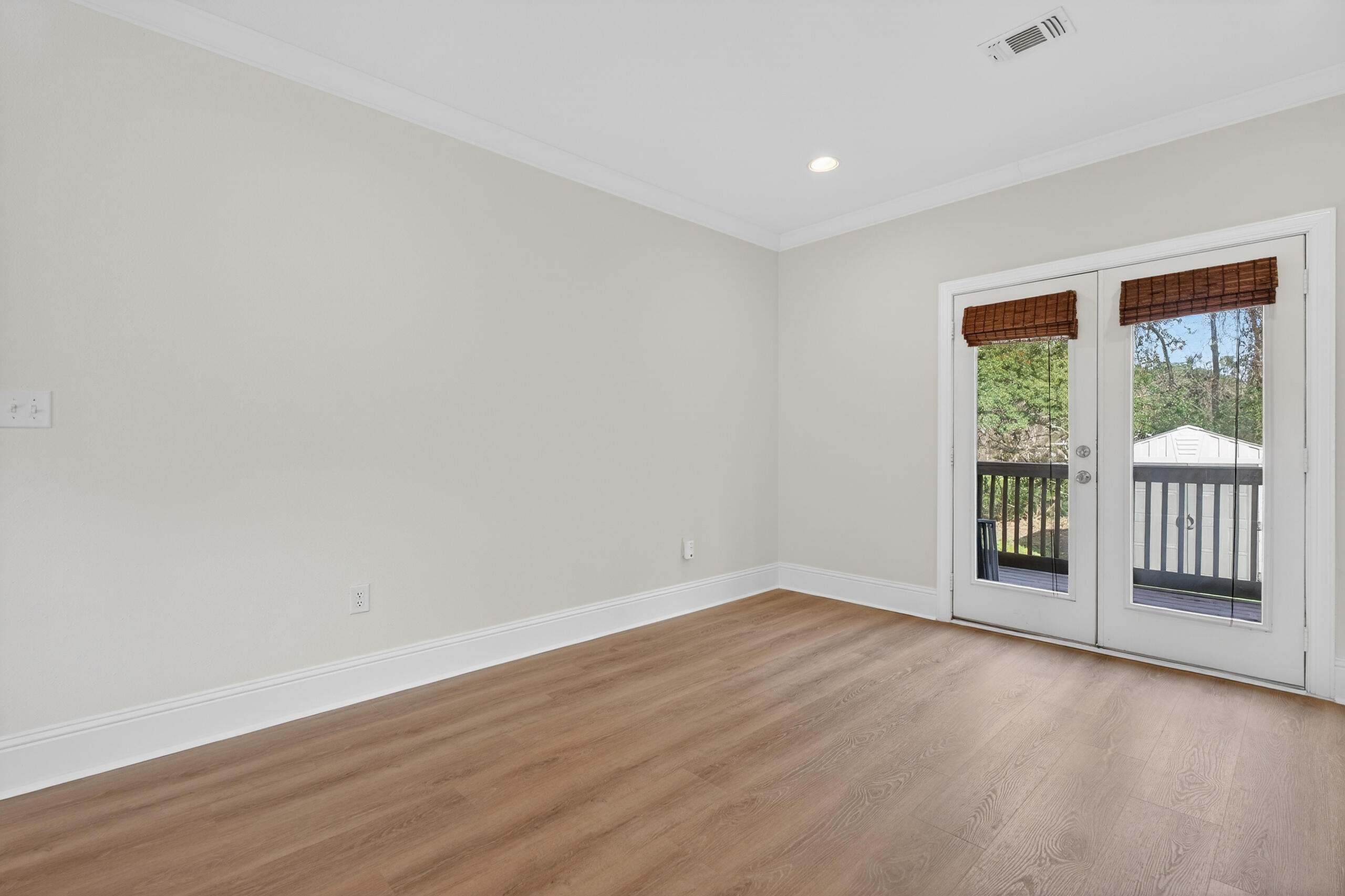 159 7th Street Santa Rosa Beach, FL 32459 - Photo 17 of 53 a view of an empty room with wooden floor and fan