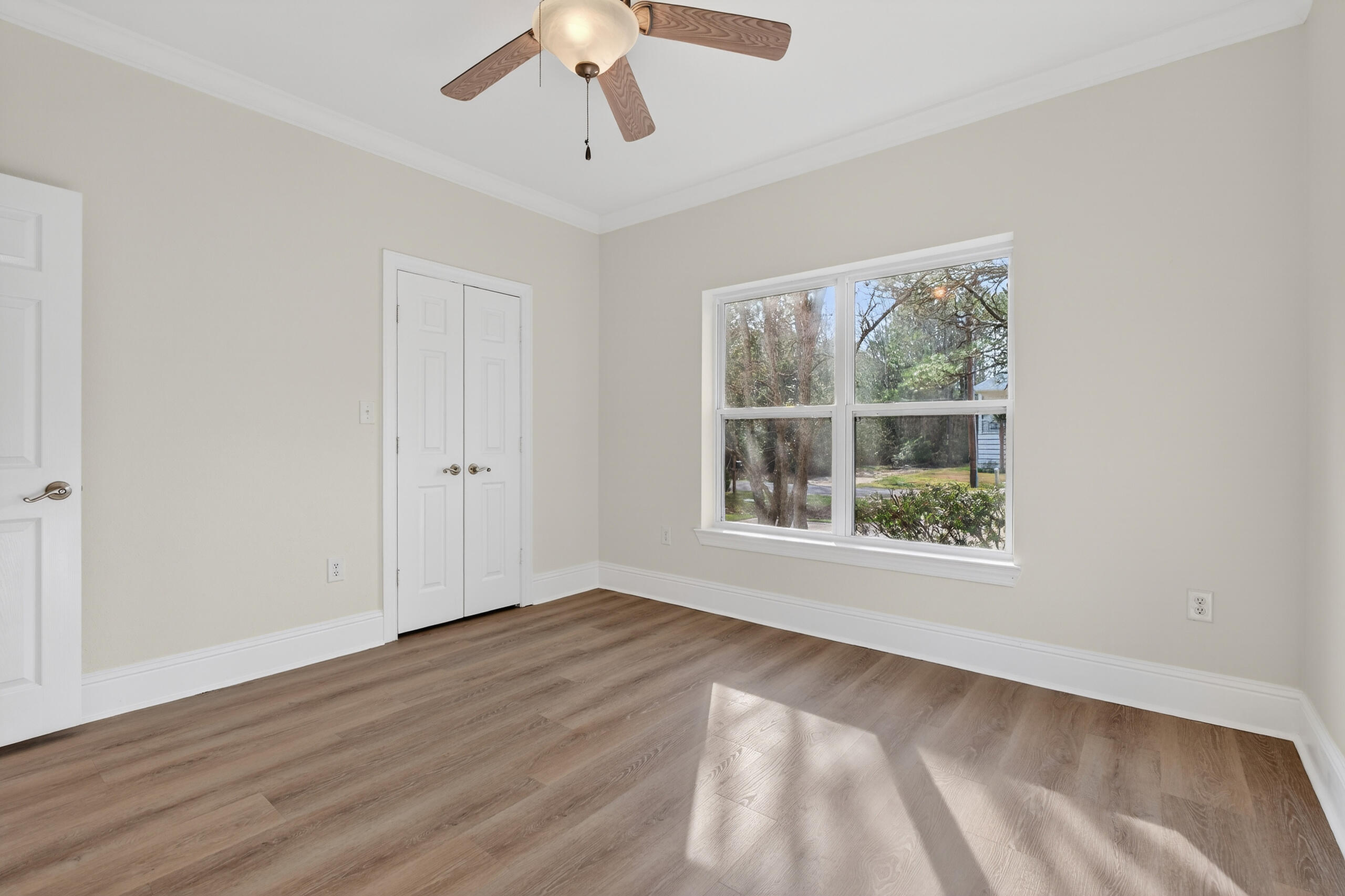 159 7th Street Santa Rosa Beach, FL 32459 - Photo 33 of 53 a view of an empty room with wooden floor and a window