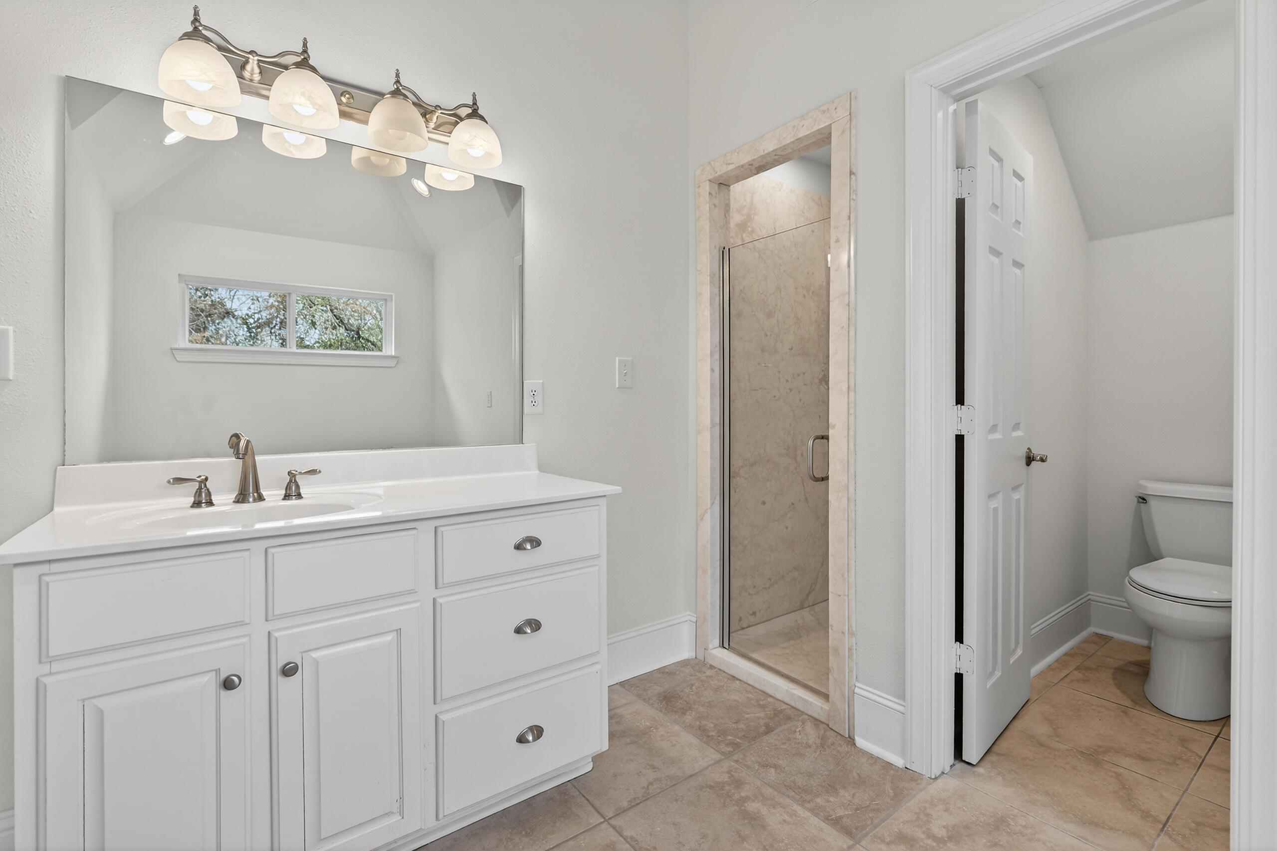159 7th Street Santa Rosa Beach, FL 32459 - Photo 43 of 53 a spacious bathroom with a toilet sink and a mirror