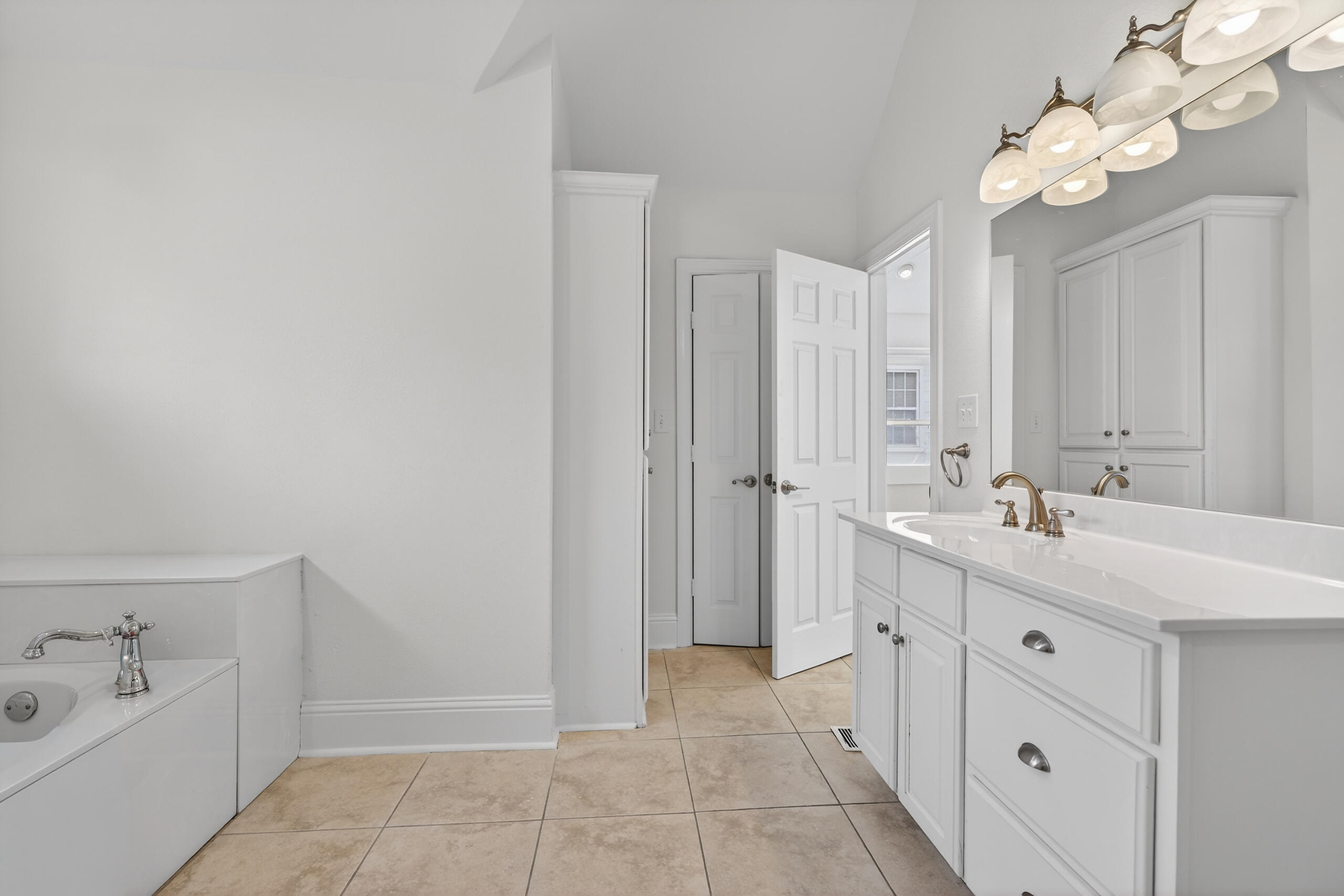 159 7th Street Santa Rosa Beach, FL 32459 - Photo 47 of 53 a spacious bathroom with a double vanity sink a mirror and a bathtub