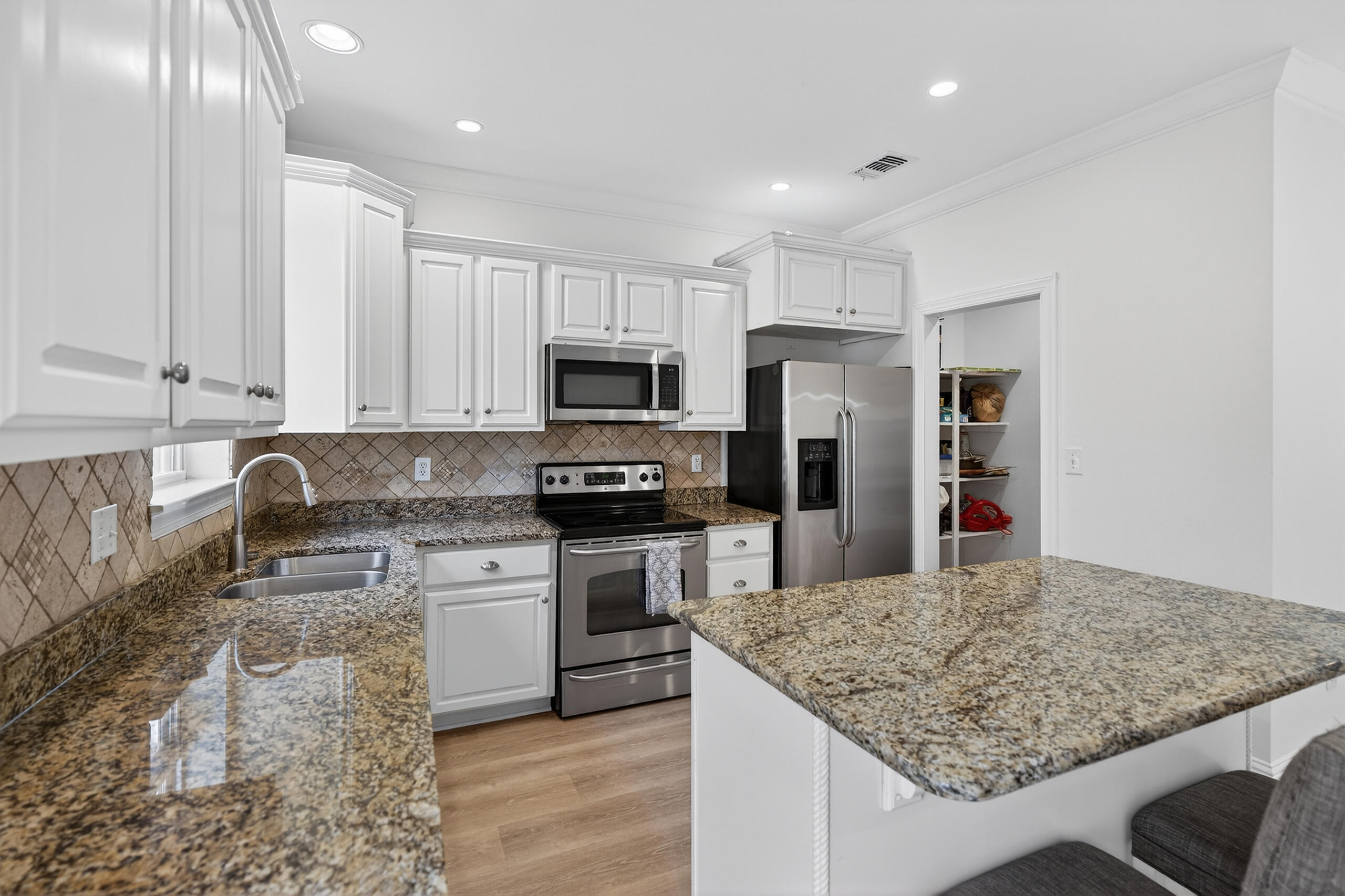 159 7th Street Santa Rosa Beach, FL 32459 - Photo 10 of 53 a kitchen with stainless steel appliances granite countertop a sink stove and refrigerator