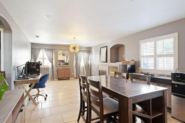 a view of a dining room with furniture and a window
