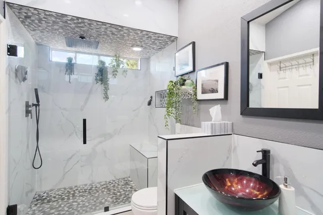 a bathroom with a toilet a sink and shower