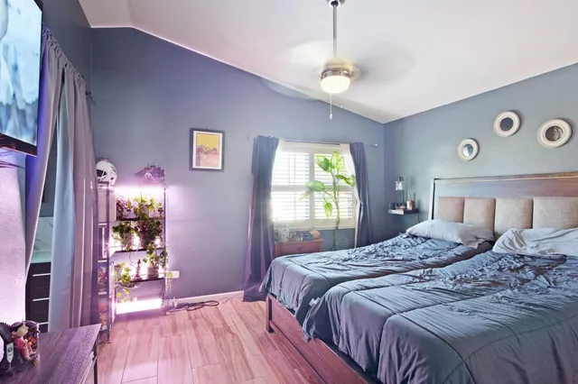 a bedroom with a bed and a window