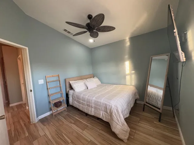 a bedroom with a bed and a large mirror