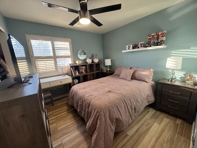 a bedroom with a bed and wooden floor
