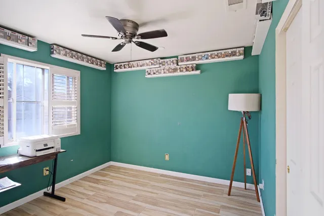 a view of a workspace with furniture and a window