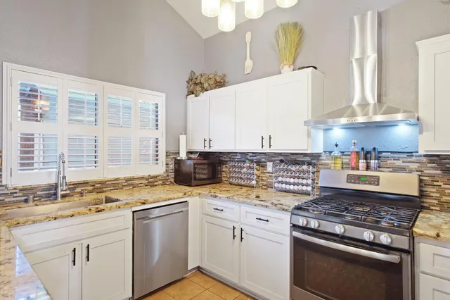 a kitchen with a stove and a sink