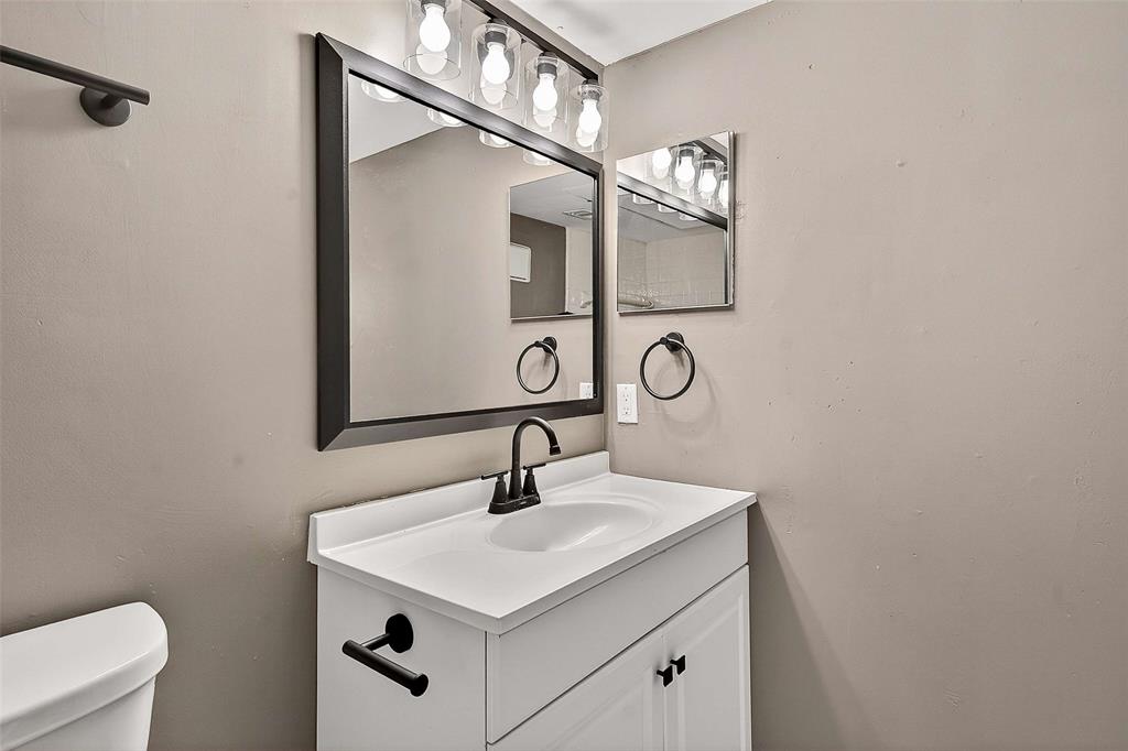 11460 Audelia Road, Unit 287 Dallas, TX 75243 - Photo 33 of 39 Half bathroom featuring vanity and toilet