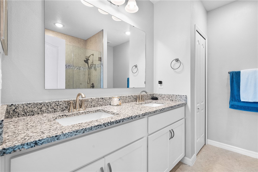 6187 Red Maple Manor Vero Beach, FL 32966 - Photo 17 of 31 a bathroom with a granite countertop sink double and mirror