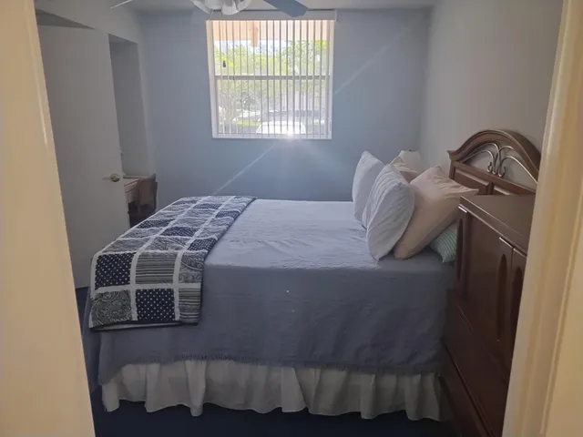 a bedroom with a bed and window