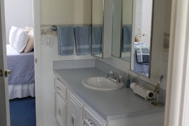 a bathroom with a sink vanity and mirror