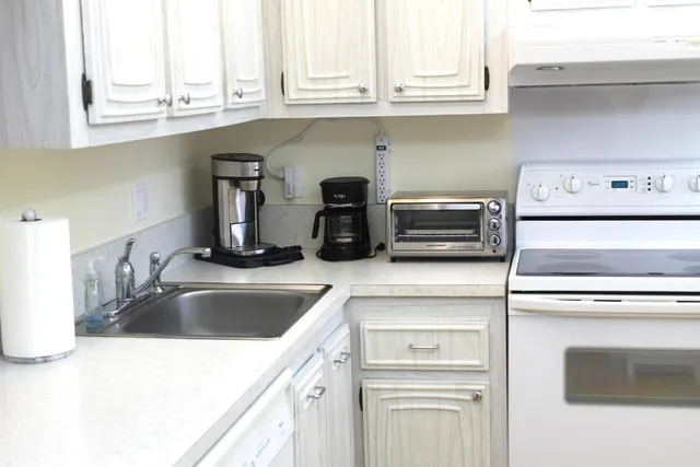 a kitchen with granite countertop a sink and a stove