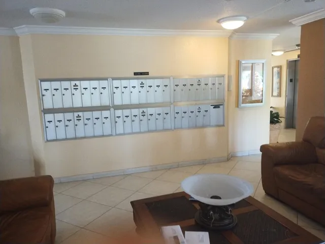 a living room with furniture a rug and a painting