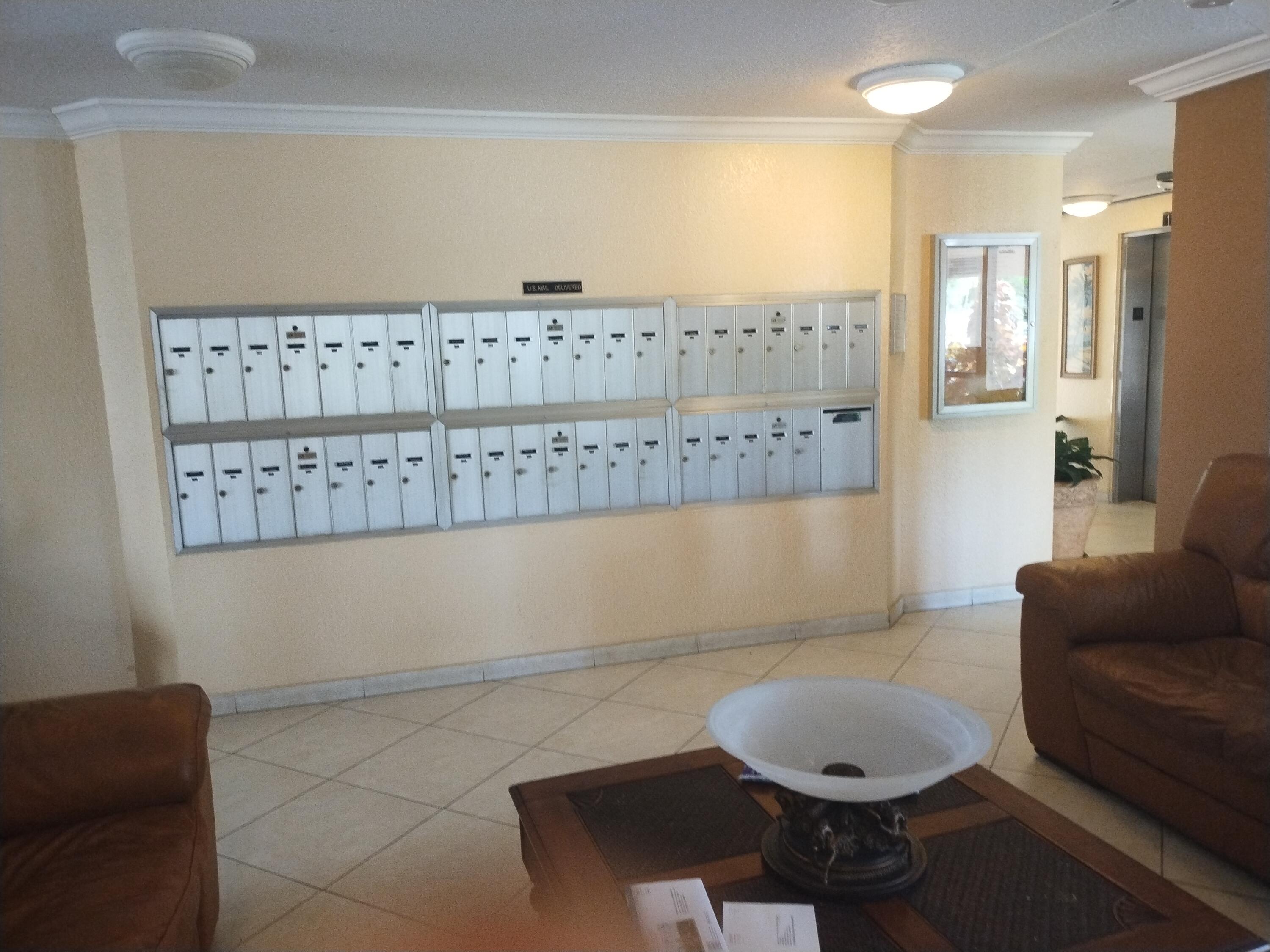 6461 Northwest 2nd Avenue, Unit 102 Boca Raton, FL 33487 - Photo 25 of 30 a living room with furniture a rug and a painting