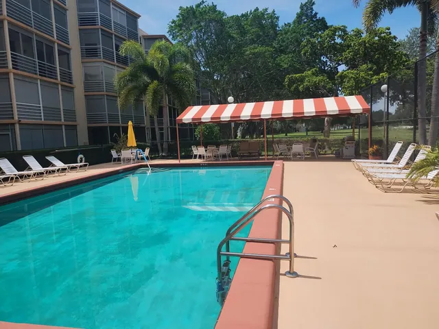 a view of swimming pool with outdoor seating and yard