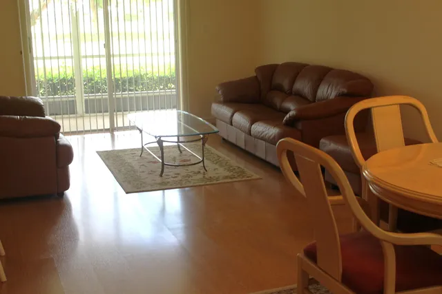 a living room with furniture and a floor to ceiling window