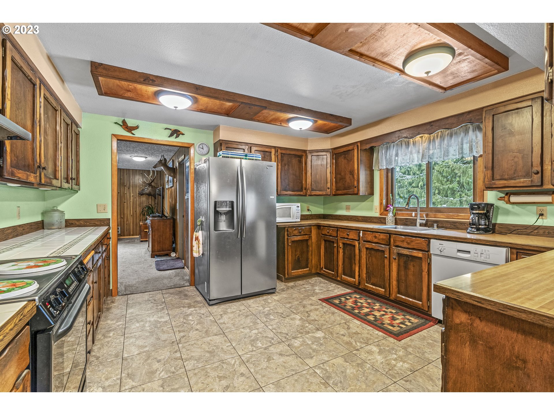 71 Stevens Road Washougal, WA 98671 - Photo 11 of 32 a kitchen with stainless steel appliances granite countertop a stove a sink and a refrigerator