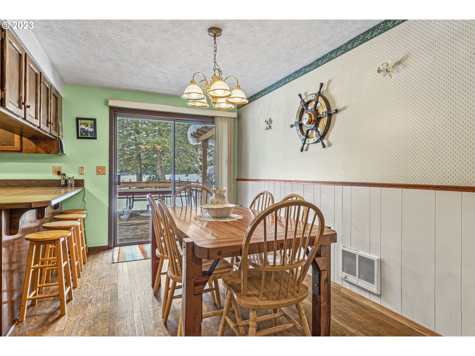 71 Stevens Road Washougal, WA 98671 - Photo 9 of 32 a view of a dining room with furniture a chandelier and wooden floor