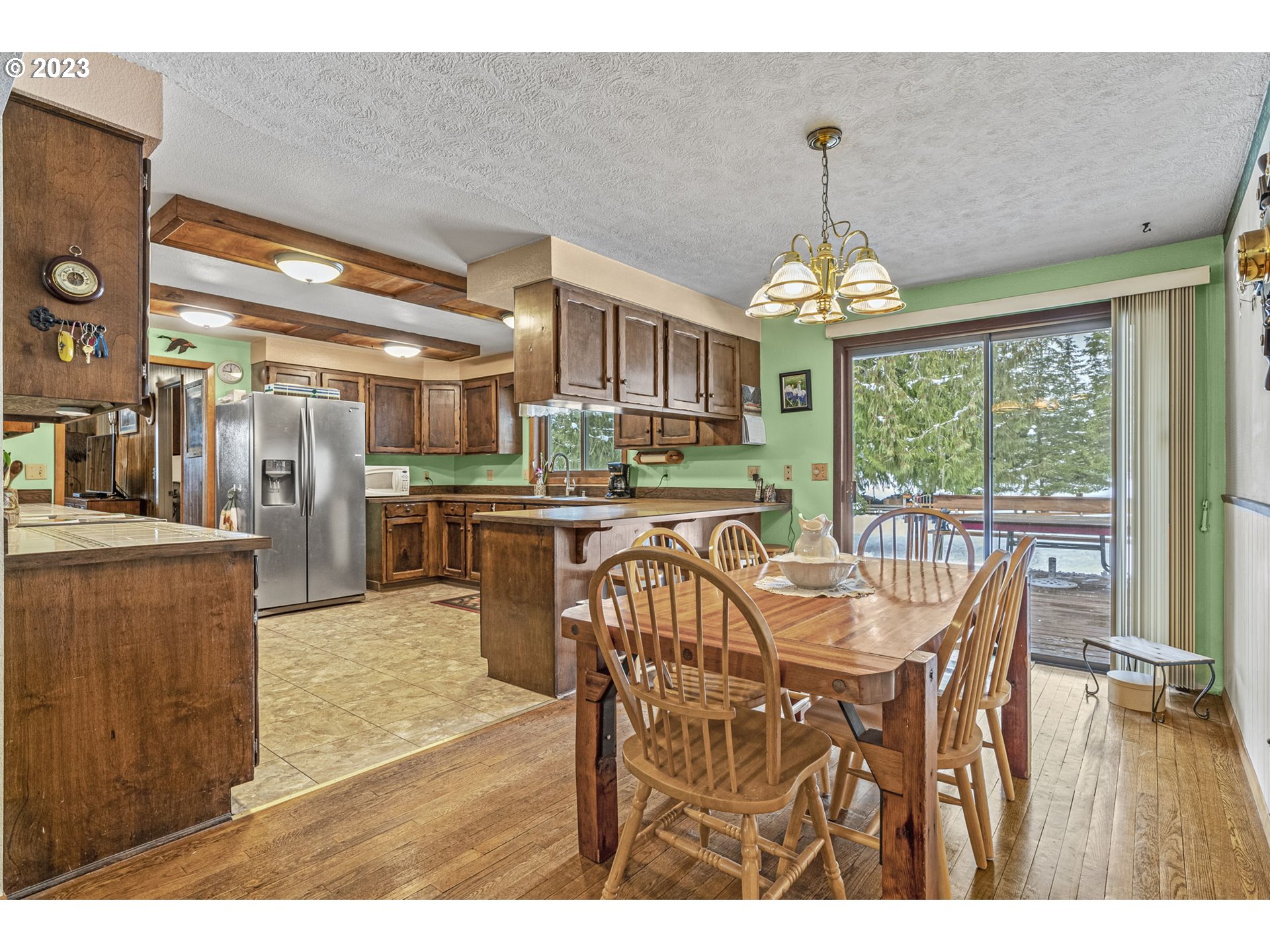 71 Stevens Road Washougal, WA 98671 - Photo 10 of 32 a dining room with furniture a chandelier and wooden floor