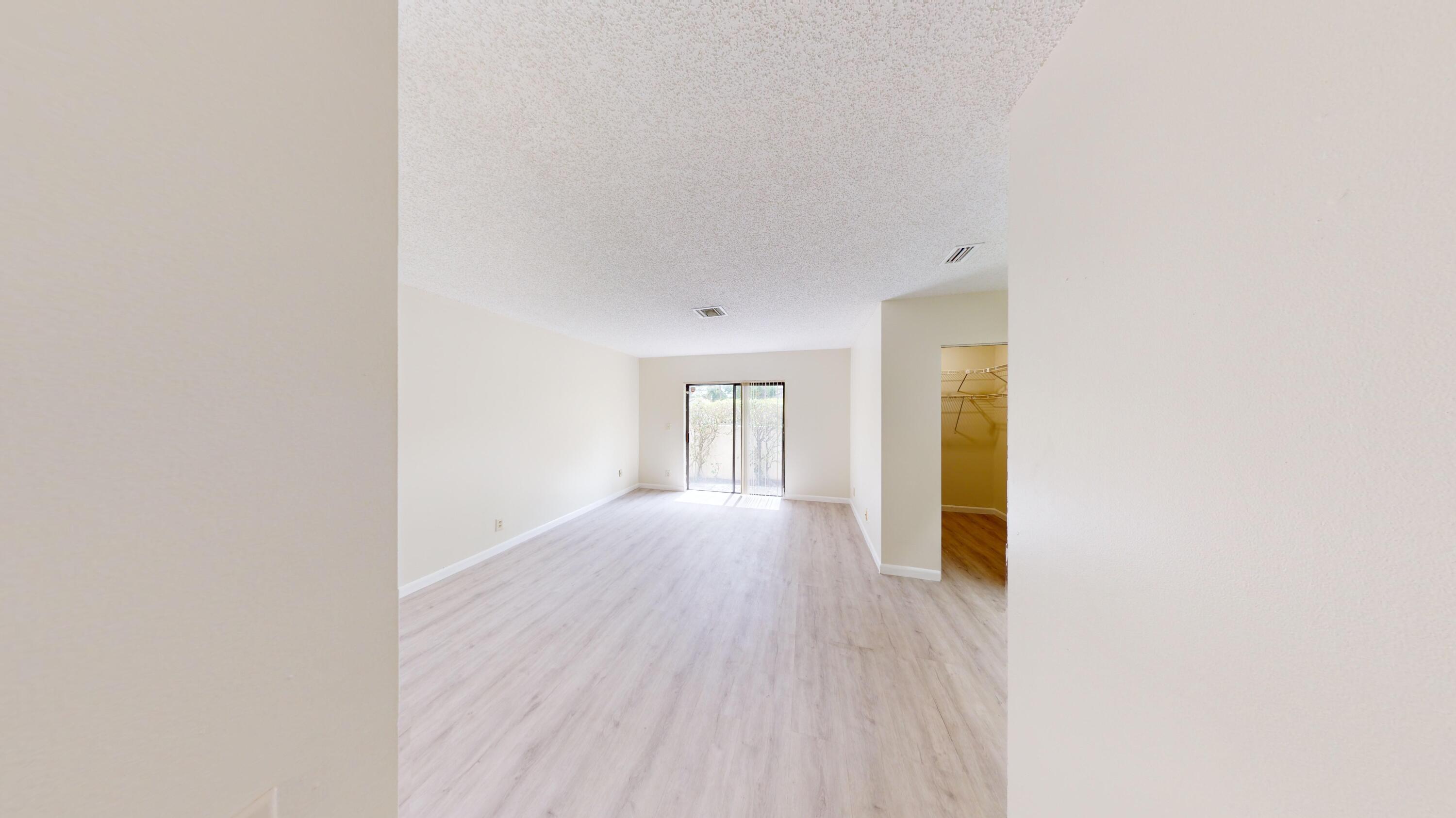 3149 Kingswood Terrace Boca Raton, FL 33431 - Photo 11 of 16 a view of an empty room with wooden floor and a window