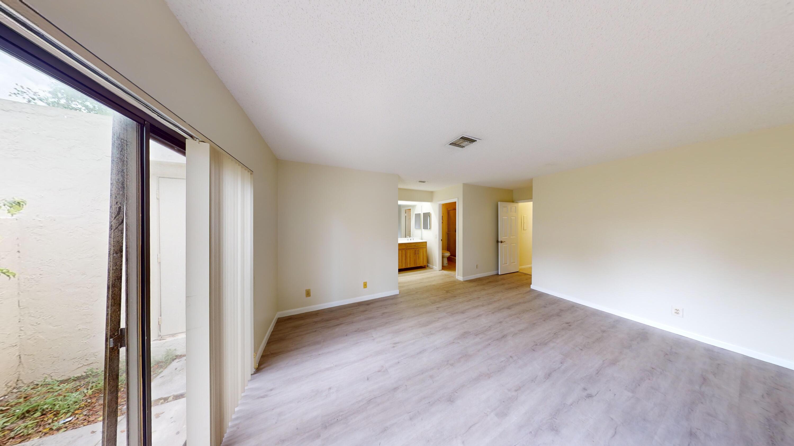 3149 Kingswood Terrace Boca Raton, FL 33431 - Photo 12 of 16 an empty room with wooden floor and windows