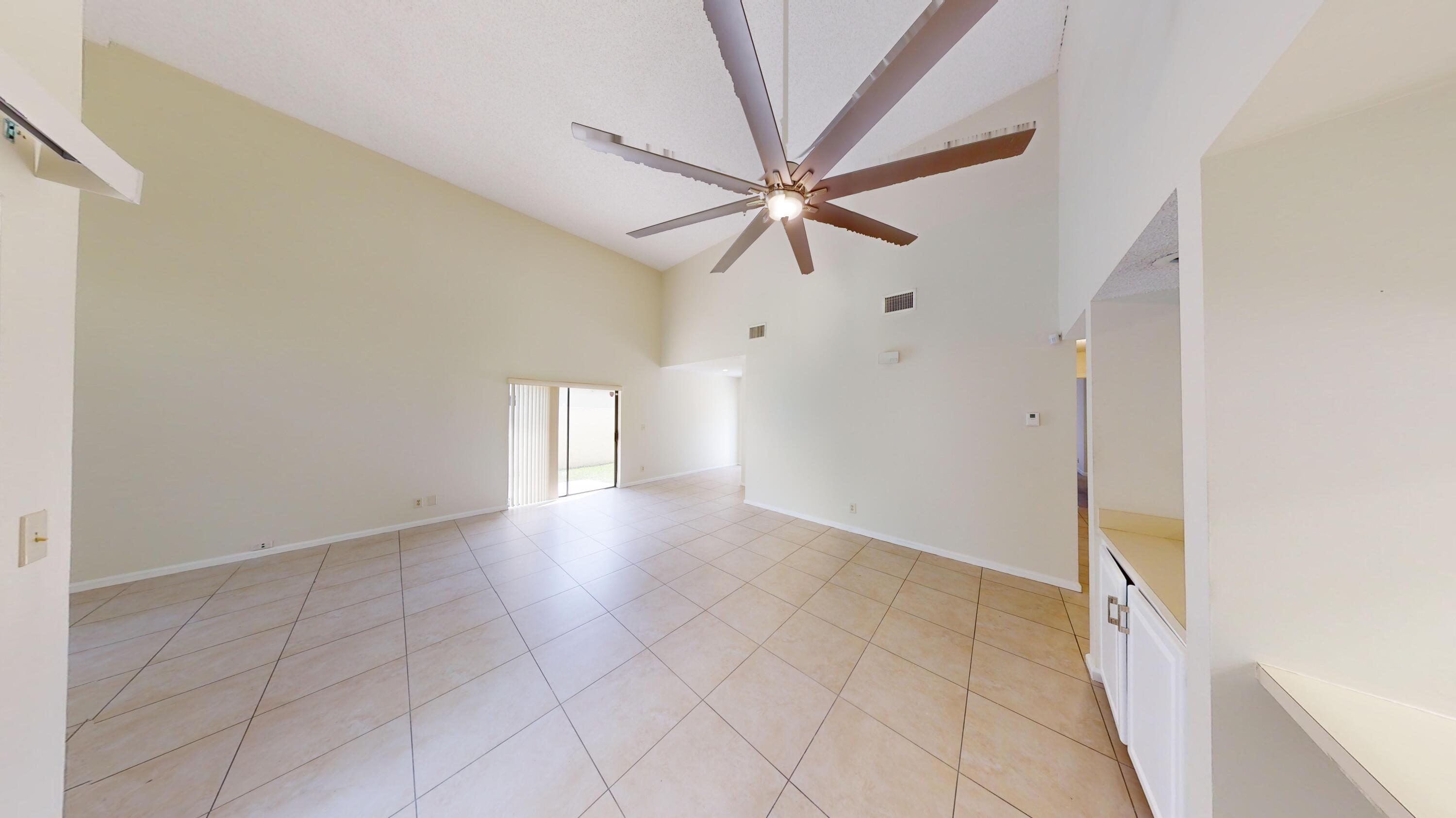 3149 Kingswood Terrace Boca Raton, FL 33431 - Photo 4 of 16 an empty room with fan and windows