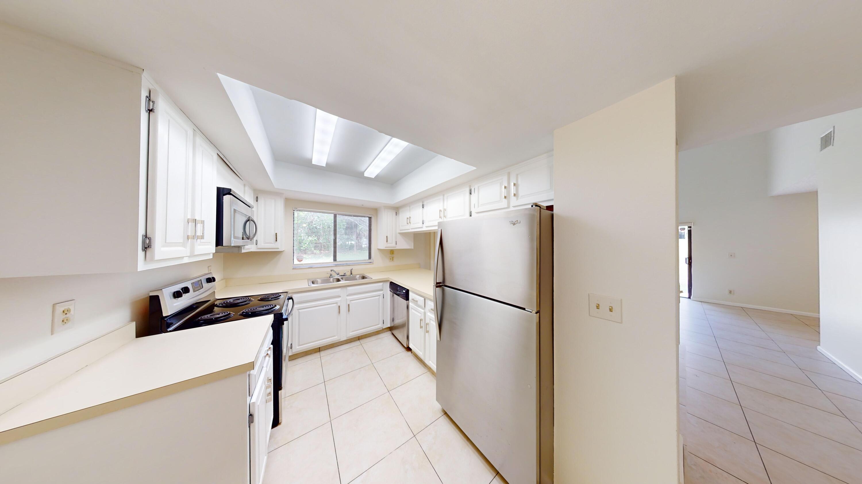 3149 Kingswood Terrace Boca Raton, FL 33431 - Photo 6 of 16 a kitchen with a refrigerator a sink and cabinets