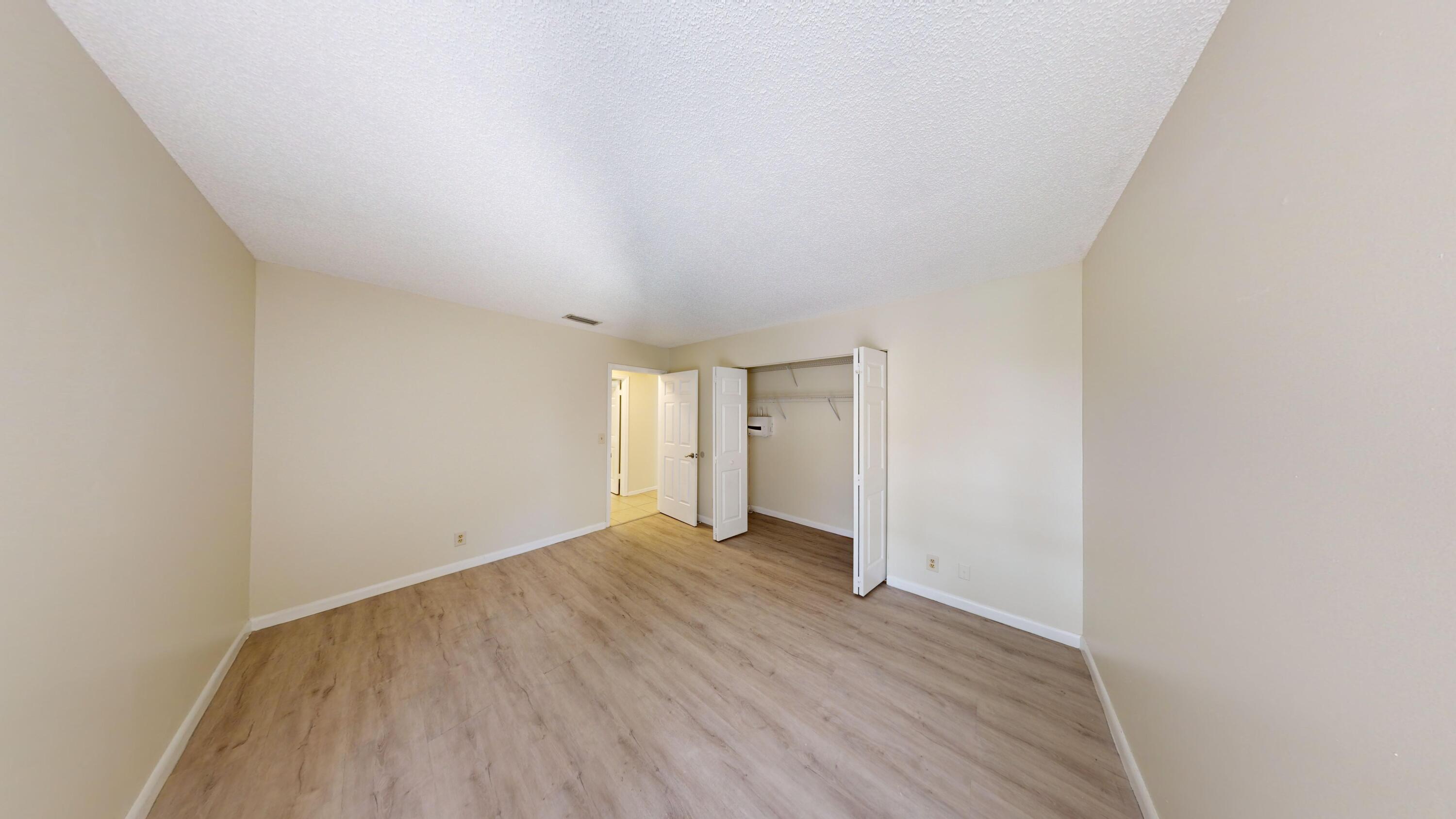 3149 Kingswood Terrace Boca Raton, FL 33431 - Photo 9 of 16 a view of an empty room with wooden floor