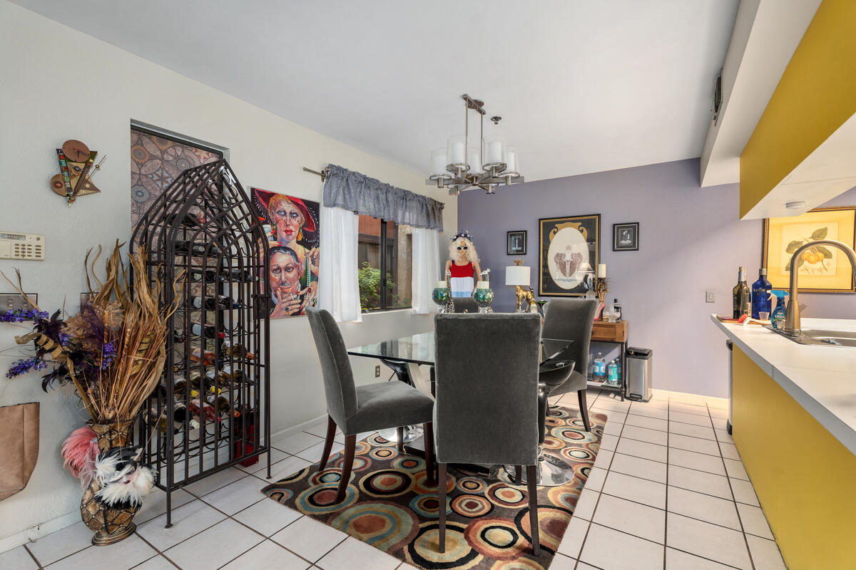 200 East Racquet Club Road, Unit 69 Palm Springs, CA 92262 - Photo 11 of 44 a view of a dining room with furniture and chandelier