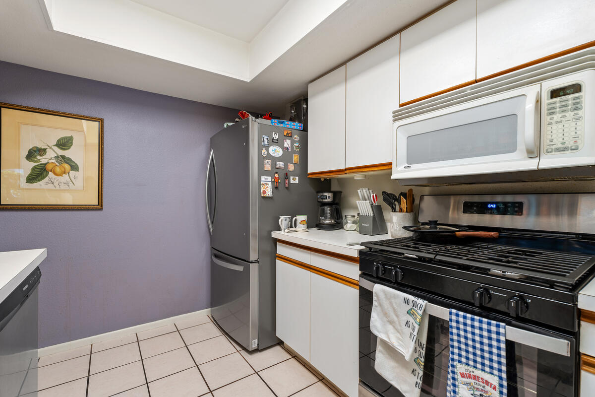 200 East Racquet Club Road, Unit 69 Palm Springs, CA 92262 - Photo 12 of 44 a kitchen with stainless steel appliances granite countertop a stove a refrigerator and a microwave