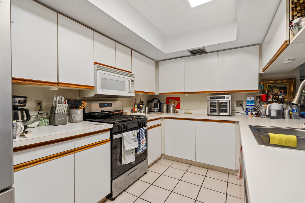200 East Racquet Club Road, Unit 69 Palm Springs, CA 92262 - Photo 13 of 44 a kitchen with granite countertop a sink a stove and cabinets