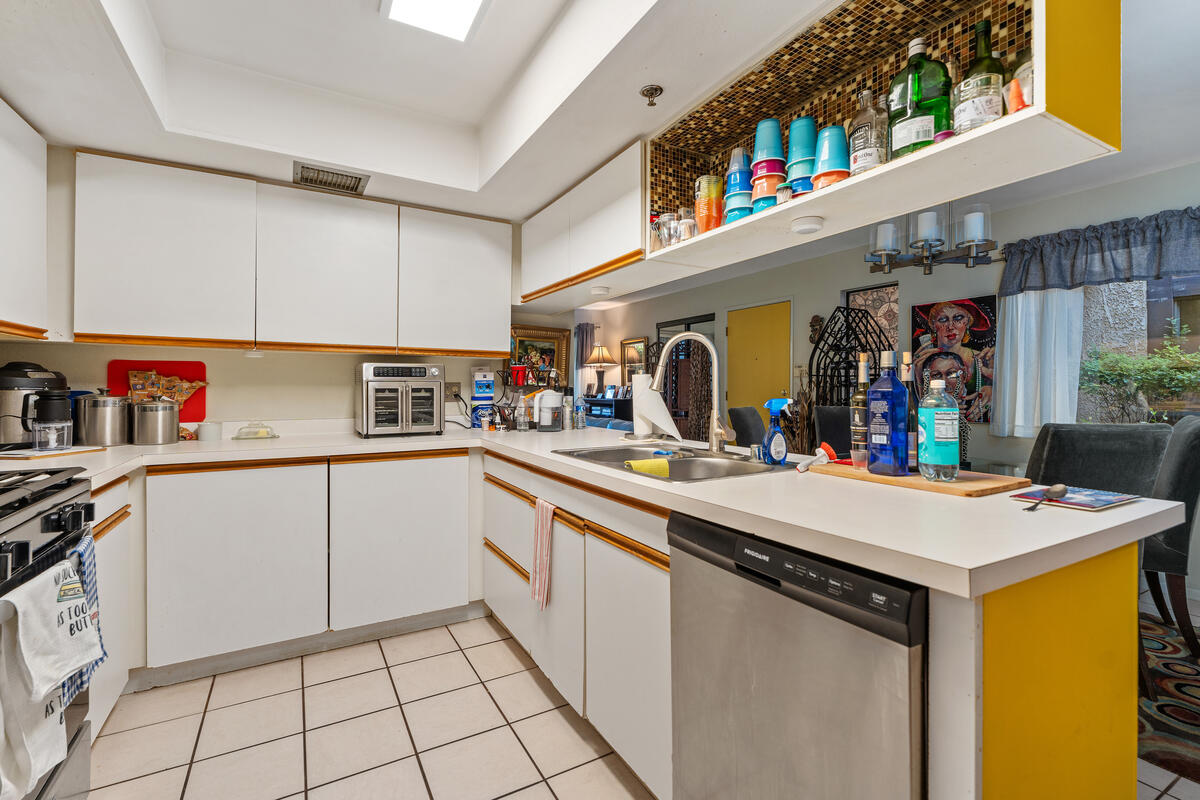 200 East Racquet Club Road, Unit 69 Palm Springs, CA 92262 - Photo 14 of 44 a kitchen with a sink a stove top oven and cabinets