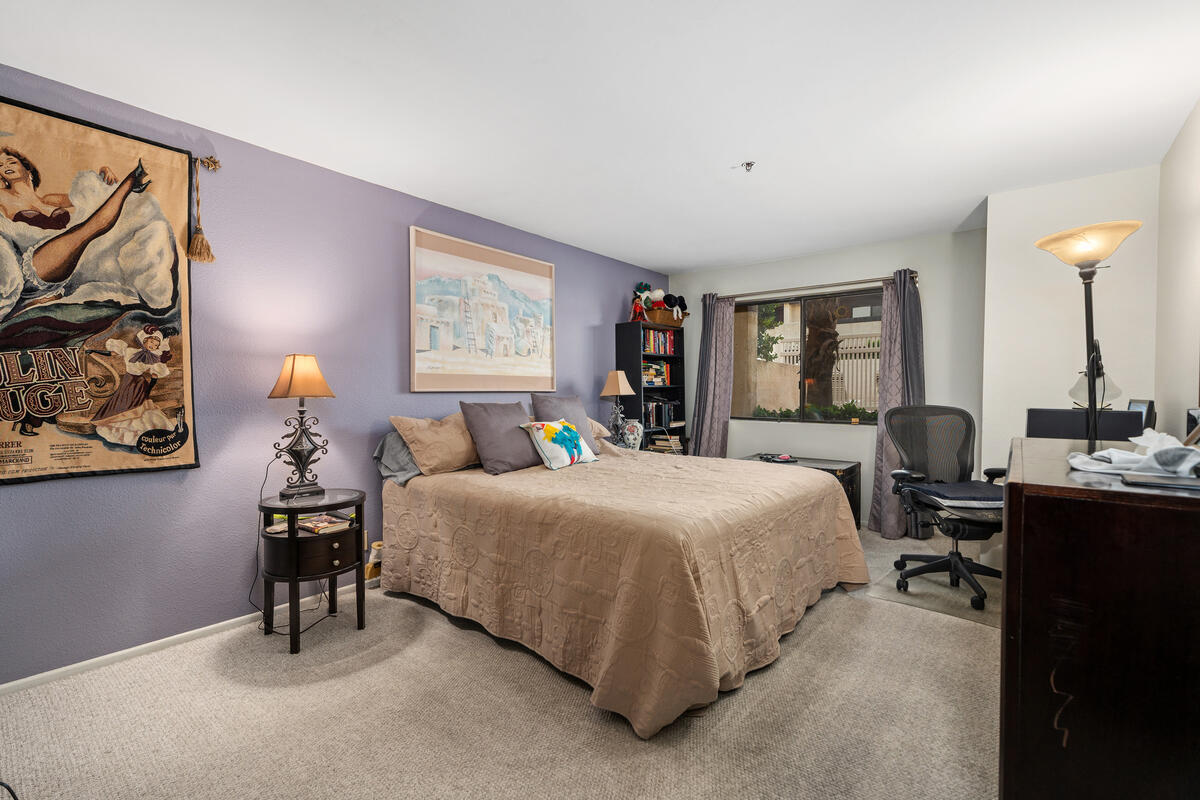 200 East Racquet Club Road, Unit 69 Palm Springs, CA 92262 - Photo 19 of 44 a bedroom with a bed and a table in it